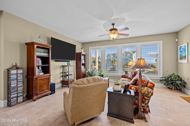 tiled living room with ceiling fan