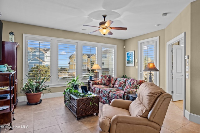 living room with ceiling fan and light tile patterned flooring