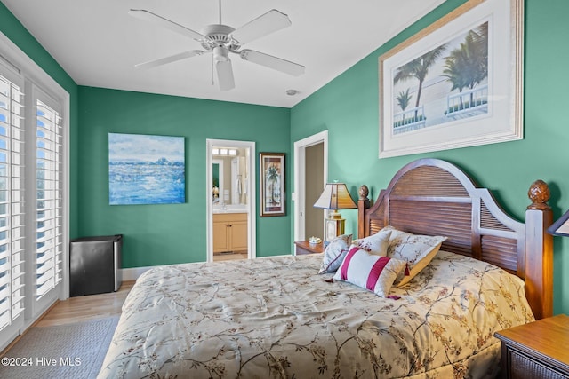 bedroom featuring ensuite bath, light hardwood / wood-style flooring, and ceiling fan