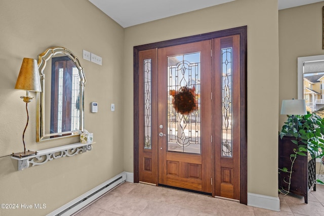 tiled foyer with a wealth of natural light and a baseboard heating unit