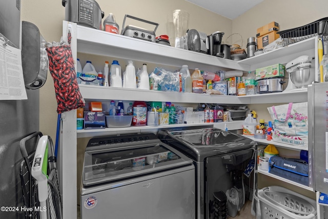 clothes washing area featuring separate washer and dryer