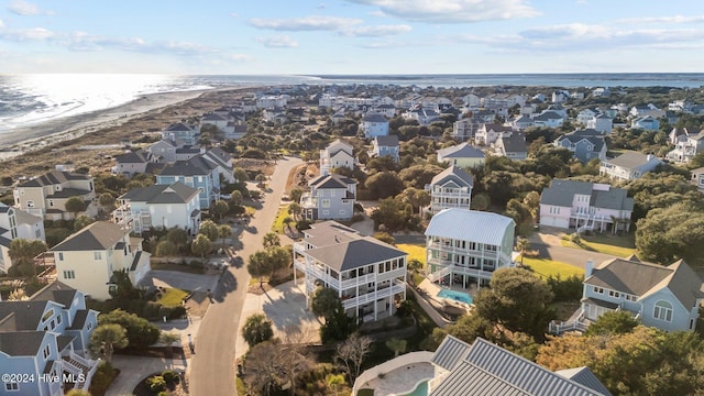 birds eye view of property featuring a beach view and a water view