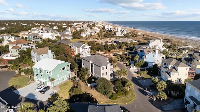 drone / aerial view with a water view and a beach view