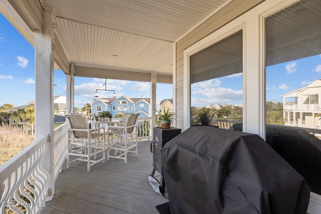 10108 Sea Breeze Dr, Emerald Isle, NC 28594 - wooden terrace with area for grilling, a residential view, and outdoor dining space