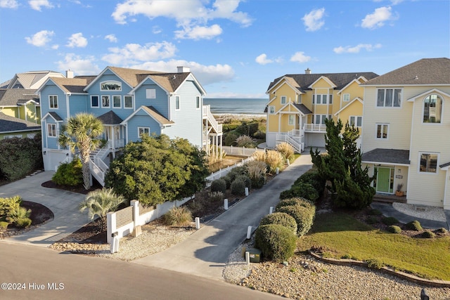 10108 Sea Breeze Dr, Emerald Isle, NC 28594 - view of front of property with a water view, concrete driveway, stairway, an attached garage, and a residential view