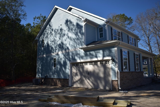 view of home's exterior featuring cooling unit and a garage