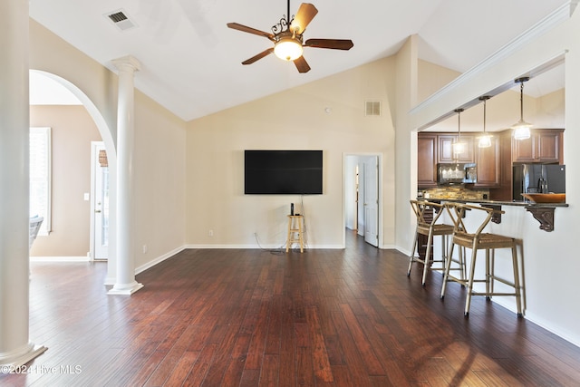 864 Sandpiper Bay Dr SW, Sunset Beach, NC 28468 - living area featuring arched walkways, dark wood-type flooring, a ceiling fan, ornate columns, and high vaulted ceiling