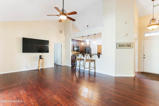 unfurnished living room featuring ceiling fan, high vaulted ceiling, and dark hardwood / wood-style floors