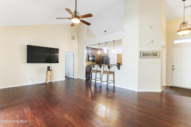 864 Sandpiper Bay Dr SW, Sunset Beach, NC 28468 - living room with high vaulted ceiling, ceiling fan, and dark wood-style floors