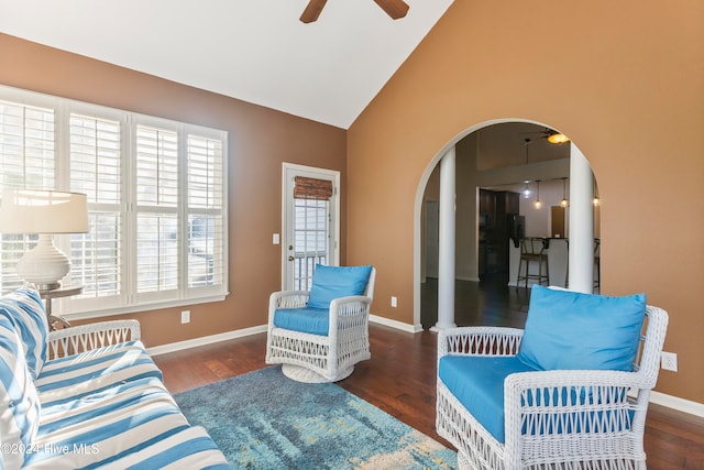 living room featuring ceiling fan, high vaulted ceiling, and dark wood-type flooring