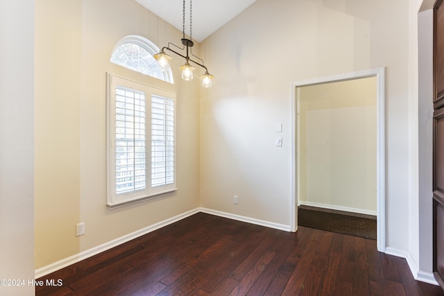 864 Sandpiper Bay Dr SW, Sunset Beach, NC 28468 - unfurnished room featuring dark wood-style flooring and high vaulted ceiling