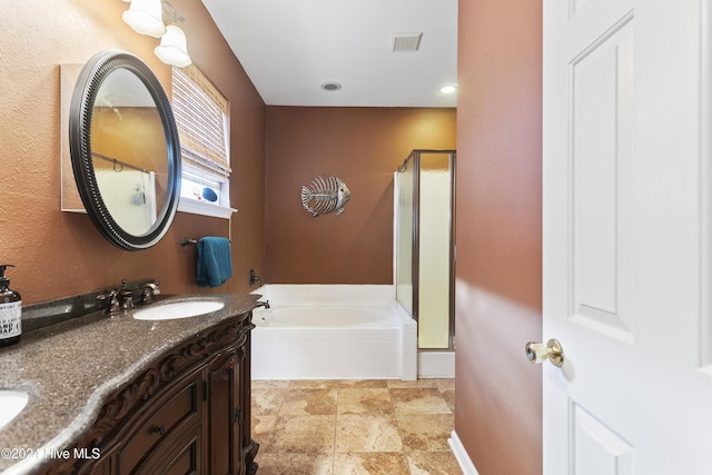 864 Sandpiper Bay Dr SW, Sunset Beach, NC 28468 - bathroom featuring a stall shower, a bath, double vanity, stone finish floors, and recessed lighting