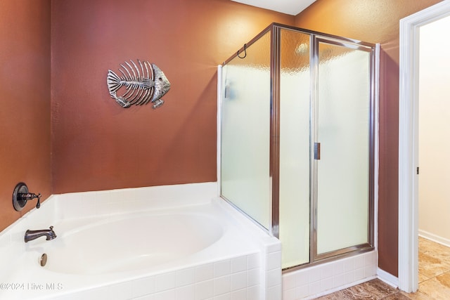 bathroom featuring tile patterned flooring and shower with separate bathtub