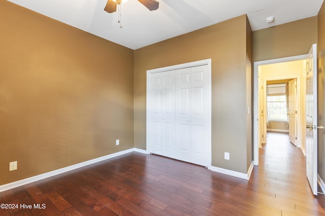 864 Sandpiper Bay Dr SW, Sunset Beach, NC 28468 - unfurnished bedroom featuring hardwood / wood-style floors, a closet, and a ceiling fan