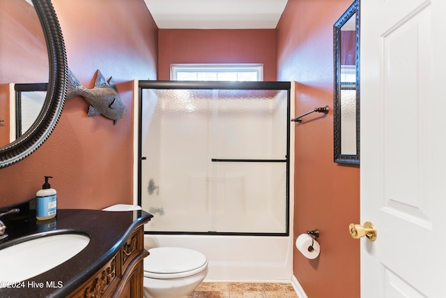 full bathroom with vanity, toilet, and enclosed tub / shower combo