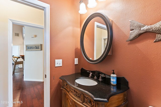 bathroom with hardwood / wood-style floors and vanity