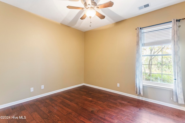 spare room with ceiling fan and dark hardwood / wood-style floors