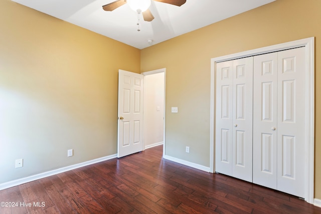 unfurnished bedroom featuring ceiling fan, dark hardwood / wood-style floors, and a closet