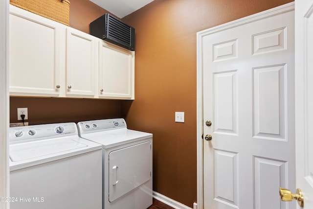 clothes washing area featuring cabinets and independent washer and dryer