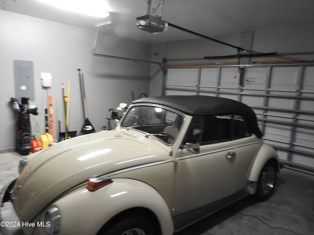 garage with electric panel and a garage door opener