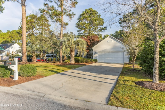 view of front of property featuring a front lawn and a garage