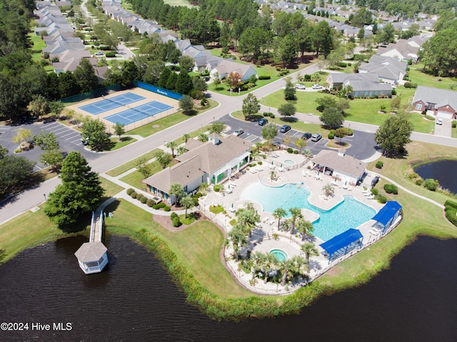 864 Sandpiper Bay Dr SW, Sunset Beach, NC 28468 - aerial perspective of suburban area featuring a pool area and a nearby body of water