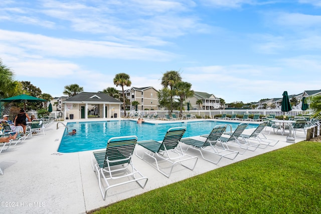 view of pool featuring a lawn and a patio area