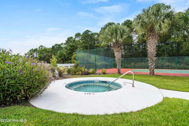 view of swimming pool with a community hot tub and a lawn