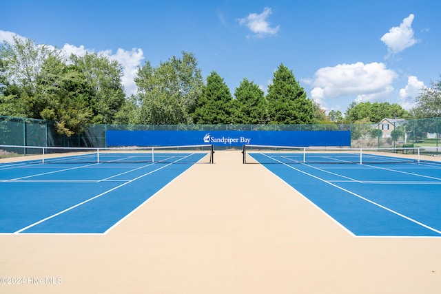 view of tennis court with basketball hoop