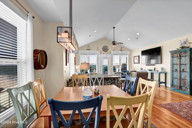 dining area with light hardwood / wood-style floors, ceiling fan, and lofted ceiling