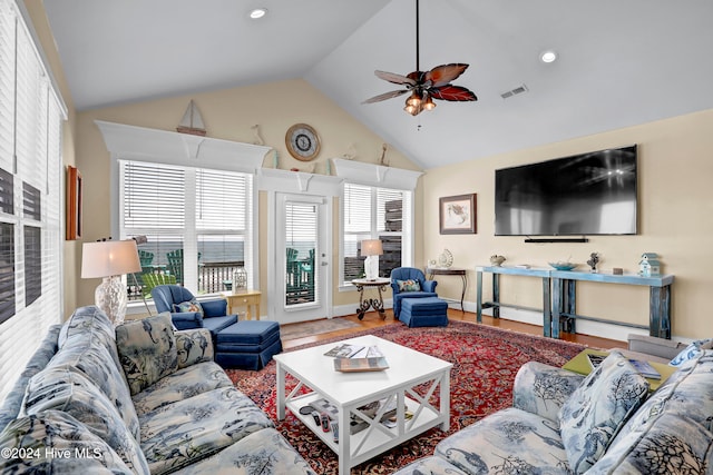 living room featuring hardwood / wood-style floors, plenty of natural light, ceiling fan, and high vaulted ceiling