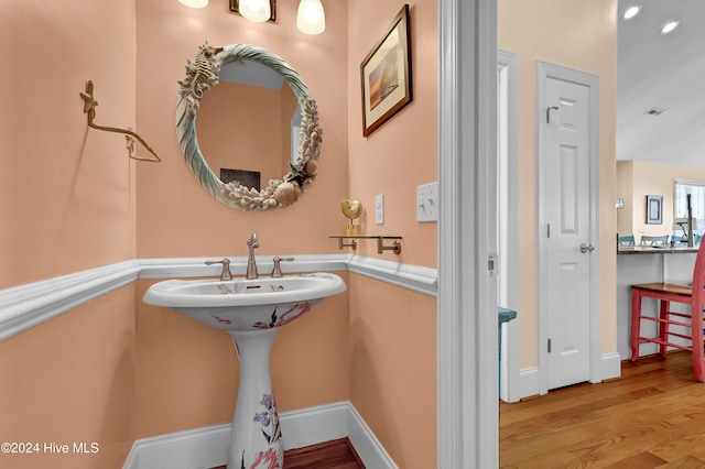 bathroom with hardwood / wood-style floors