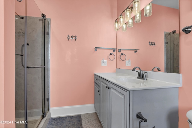 bathroom with tile patterned flooring, vanity, and an enclosed shower