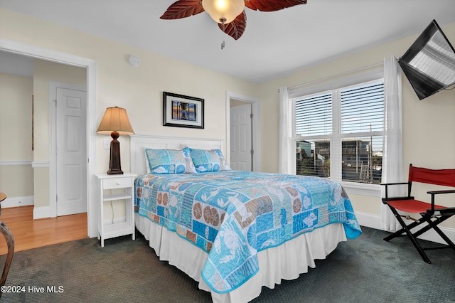 bedroom with ceiling fan and dark carpet