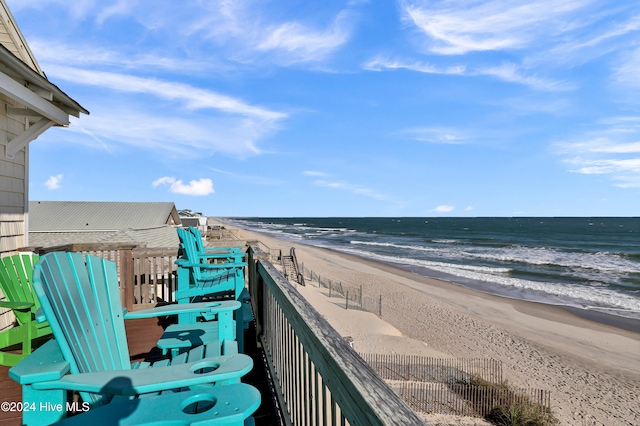 balcony featuring a water view and a beach view