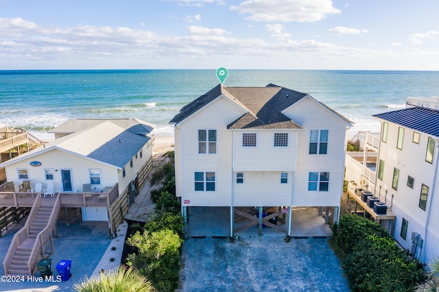 drone / aerial view featuring a water view and a view of the beach