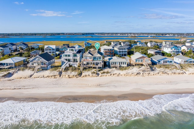 bird's eye view featuring a water view and a view of the beach