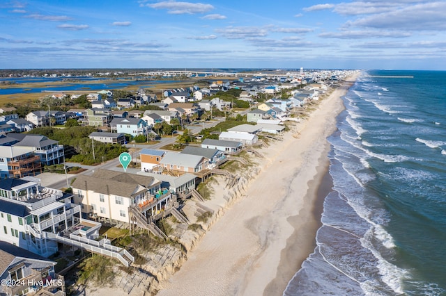 drone / aerial view with a water view and a beach view