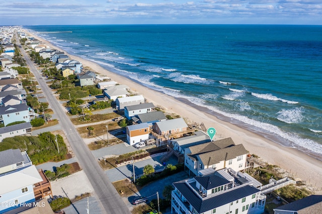 drone / aerial view with a water view and a beach view