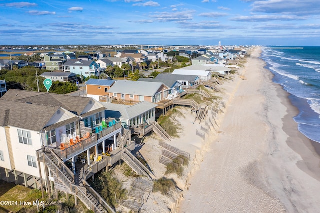 bird's eye view featuring a view of the beach and a water view