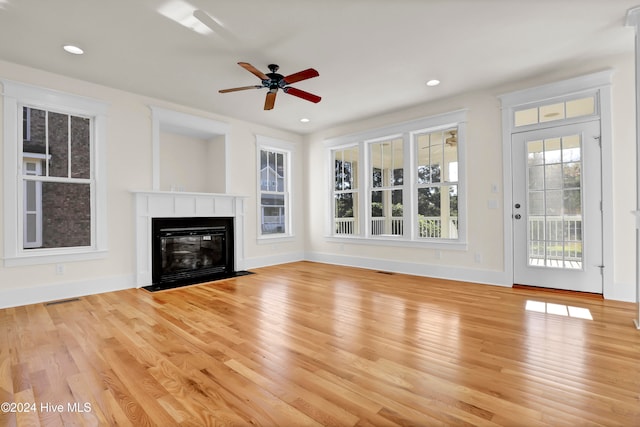 unfurnished living room with ceiling fan and light hardwood / wood-style flooring