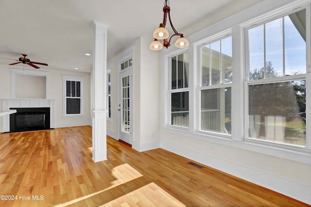 unfurnished living room featuring ceiling fan and light hardwood / wood-style floors