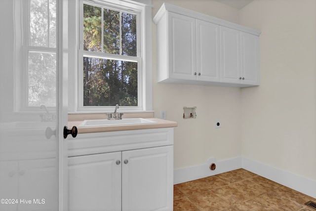 laundry room featuring electric dryer hookup, a healthy amount of sunlight, sink, and washer hookup