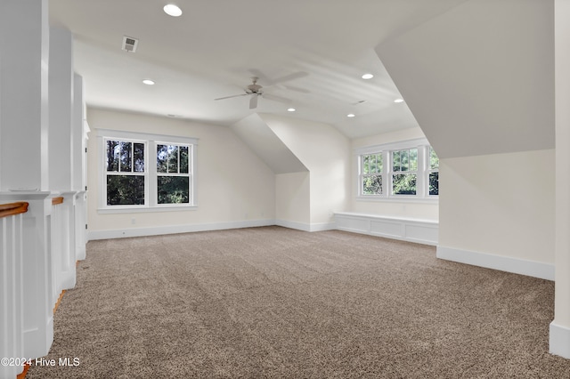 additional living space with ceiling fan, carpet floors, and lofted ceiling