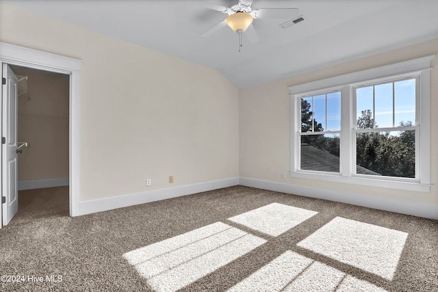 spare room with carpet, ceiling fan, and lofted ceiling