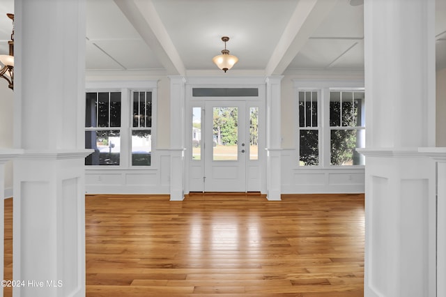 foyer entrance with beam ceiling and hardwood / wood-style flooring