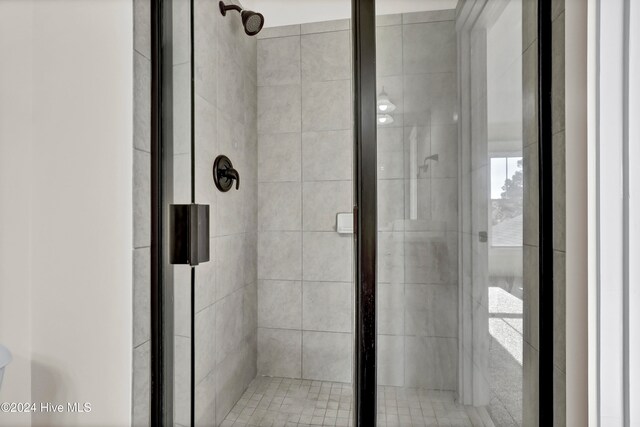 bathroom featuring a shower with door