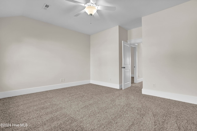 empty room with carpet flooring, ceiling fan, and vaulted ceiling