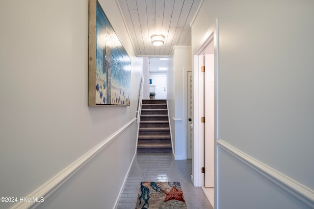 hall with light tile patterned floors and wooden ceiling