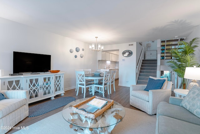 living room featuring a chandelier and wood-type flooring